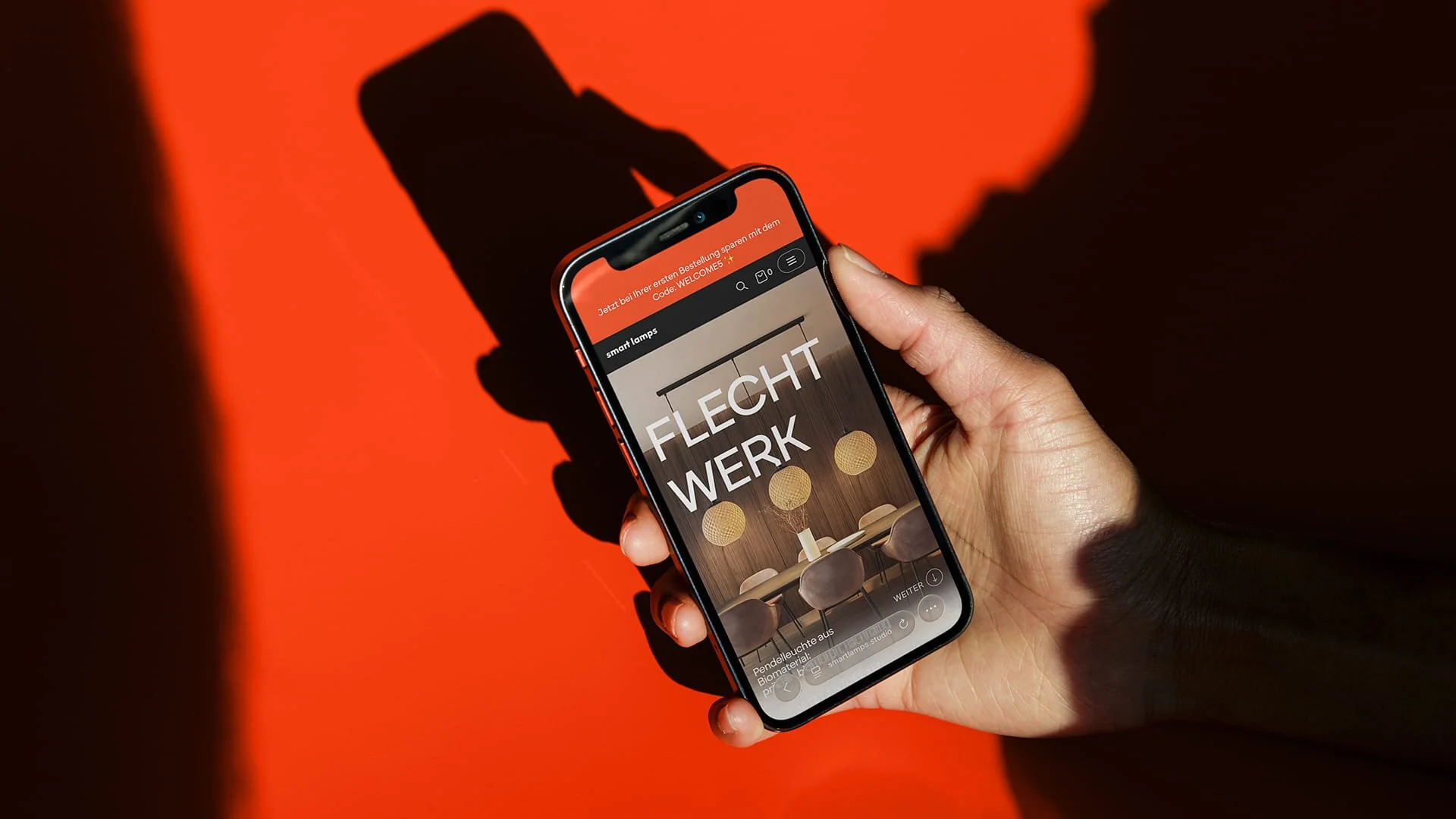 Hand holding a smartphone displaying the smart lamps online shop