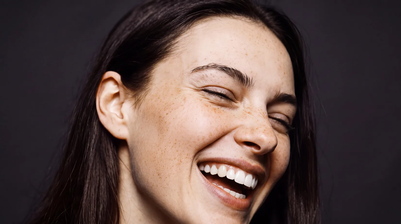 Portrait of a laughing woman from the BISS PUNKT dental laboratory brand identity