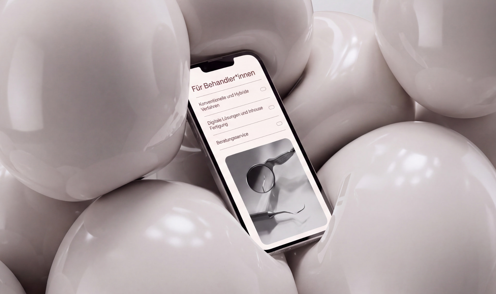 BISS PUNKT website for Für Behandler*innen on a smartphone screen resting between glossy tooth-like shapes